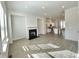 Bright living room with a fireplace, open floor plan, and a view into the kitchen at 741 Cordele Ln, Sugar Hill, GA 30518