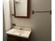 Bathroom features a wood cabinet sink, framed mirror and towel rack at 816 Cedar Lake Se Dr, Conyers, GA 30094