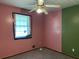 Bedroom featuring pink walls, green accent wall, ceiling fan and window at 816 Cedar Lake Se Dr, Conyers, GA 30094