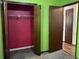 Bedroom view showcasing folding closet doors, green walls, and beige carpet at 816 Cedar Lake Se Dr, Conyers, GA 30094