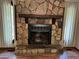Stone fireplace with wooden mantle, hearth, and metal firebox at 816 Cedar Lake Se Dr, Conyers, GA 30094