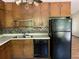 A functional kitchen with wood cabinets, modern appliances, and a view of the yard at 816 Cedar Lake Se Dr, Conyers, GA 30094