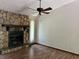 Living room featuring a stone fireplace, wood floors, and a ceiling fan at 816 Cedar Lake Se Dr, Conyers, GA 30094
