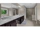 Primary bathroom with double vanity, granite counters, and glass shower at 935 Grove Valley Drive Dr, Cumming, GA 30041