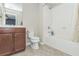 Bathroom features a tiled shower over tub, wood vanity, and neutral color palette at 935 Grove Valley Drive Dr, Cumming, GA 30041