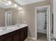 Well lit bathroom featuring double vanity, large mirror, and a separate bath and shower at 935 Grove Valley Drive Dr, Cumming, GA 30041