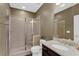 Well-lit bathroom featuring a glass shower and granite countertop at 935 Grove Valley Drive Dr, Cumming, GA 30041