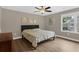 Simple bedroom with hardwood floors and a bright sunny window at 935 Grove Valley Drive Dr, Cumming, GA 30041