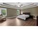 Primary bedroom with trey ceilings, ceiling fan, and two large windows at 935 Grove Valley Drive Dr, Cumming, GA 30041