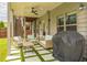 Cozy covered patio with stylish seating, a ceiling fan, and a grill, creating an inviting outdoor space at 935 Grove Valley Drive Dr, Cumming, GA 30041