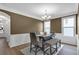 Dining room with neutral colors, chair rail, and modern chandelier at 935 Grove Valley Drive Dr, Cumming, GA 30041