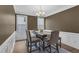 Dining room with neutral colors, chair rail, and modern chandelier at 935 Grove Valley Drive Dr, Cumming, GA 30041