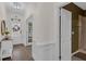 Welcoming entryway with hardwood floors, decorative molding, and a glimpse of the adjacent bathroom at 935 Grove Valley Drive Dr, Cumming, GA 30041