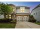 Charming two-story home with brick and siding, a two-car garage, and a well-manicured lawn at 935 Grove Valley Drive Dr, Cumming, GA 30041