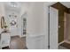 Bright foyer featuring wood floors, decorative wainscoting, and a view of the front door and a nearby bathroom at 935 Grove Valley Drive Dr, Cumming, GA 30041
