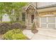 Inviting front entrance with brick accents, a covered porch, and professionally landscaped garden at 935 Grove Valley Drive Dr, Cumming, GA 30041