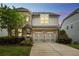 Charming two-story home with a brick and siding exterior, manicured landscaping, and a two-car garage at 935 Grove Valley Drive Dr, Cumming, GA 30041