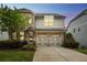 Charming two-story home featuring a brick and siding exterior, a two-car garage, and a beautifully landscaped front yard at 935 Grove Valley Drive Dr, Cumming, GA 30041