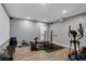 Home gym featuring an elliptical machine, squat rack and bench press at 935 Grove Valley Drive Dr, Cumming, GA 30041
