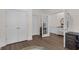 Hallway with hardwood floors showing multiple doors and access to other rooms at 935 Grove Valley Drive Dr, Cumming, GA 30041