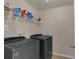 Laundry room featuring gray appliances, white shelving, and tile floors at 935 Grove Valley Drive Dr, Cumming, GA 30041