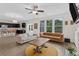 Open living room and kitchen area with large windows providing plenty of natural light at 935 Grove Valley Drive Dr, Cumming, GA 30041