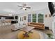 Open-concept living room featuring hardwood floors, windows, and access to the kitchen at 935 Grove Valley Drive Dr, Cumming, GA 30041