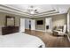 Spacious main bedroom with tray ceilings, chair, and hardwood floors at 935 Grove Valley Drive Dr, Cumming, GA 30041