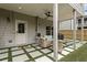 Relaxing covered patio featuring comfortable seating, a grill, and a serene backyard view at 935 Grove Valley Drive Dr, Cumming, GA 30041