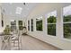 Sun room has lots of natural light, hardwood flooring and a hanging chair at 935 Grove Valley Drive Dr, Cumming, GA 30041