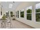 Bright sunroom with many windows and an inviting hanging chair at 935 Grove Valley Drive Dr, Cumming, GA 30041