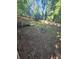 View of the backyard with lawn, wooded fence, and a stairway to the back porch at 1150 Goldsmith Rd, Stone Mountain, GA 30083