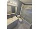 Bathroom with shower-tub combo with white and gray marble flooring and modern fixtures at 1150 Goldsmith Rd, Stone Mountain, GA 30083