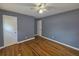 Spacious bedroom with hardwood flooring, two doors, and soft gray walls at 1150 Goldsmith Rd, Stone Mountain, GA 30083