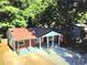 This brick home features a covered porch with classic column detailing and an asphalt roof at 1150 Goldsmith Rd, Stone Mountain, GA 30083