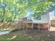 Exterior view of the back of the home with a porch, stairway, and lawn at 1150 Goldsmith Rd, Stone Mountain, GA 30083