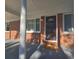 Covered front porch with view of the front door, columns, and brick facade at 1150 Goldsmith Rd, Stone Mountain, GA 30083