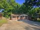 Charming brick home featuring a covered front porch with classic column detailing and a wide driveway at 1150 Goldsmith Rd, Stone Mountain, GA 30083