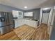 Modern kitchen featuring stainless steel refrigerator, white cabinets, and sleek countertops at 1150 Goldsmith Rd, Stone Mountain, GA 30083