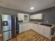 Well-lit kitchen featuring stainless steel refrigerator and granite countertops at 1150 Goldsmith Rd, Stone Mountain, GA 30083