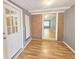 A sun room with hardwood flooring, and a view to an open doorway at 1150 Goldsmith Rd, Stone Mountain, GA 30083