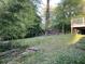 Backyard with a view of the deck and overgrown vegetation at 2039 Harwinor Se Rd, Smyrna, GA 30082