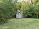 Backyard view showcasing a storage shed surrounded by greenery at 2039 Harwinor Se Rd, Smyrna, GA 30082