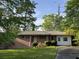 Charming single-story brick home with a well-manicured front yard and mature trees at 2039 Harwinor Se Rd, Smyrna, GA 30082
