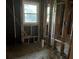 Exposed framing of an unfinished interior room with a view of the yard through a window at 2039 Harwinor Se Rd, Smyrna, GA 30082