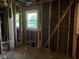This is an unfinished room with exposed framing, pipes, and windows at 2039 Harwinor Se Rd, Smyrna, GA 30082