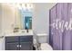 A bathroom with a single sink vanity and a purple shower curtain at 2689 Muskeg Sw Ct, Atlanta, GA 30331