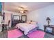 Bright bedroom with a ceiling fan, wood floors, and pink accents at 2689 Muskeg Sw Ct, Atlanta, GA 30331
