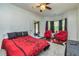 Bedroom with ceiling fan, bright red chairs, television and carpet at 2689 Muskeg Sw Ct, Atlanta, GA 30331