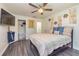 Bedroom features a bed, ceiling fan, closet, mounted tv, and decorative wall art at 2689 Muskeg Sw Ct, Atlanta, GA 30331